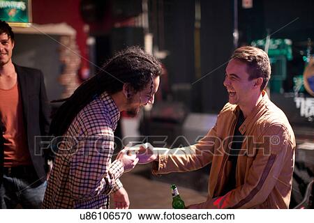 Two men greeting in bar View Large Photo Image Stock Image - Two men greeting in bar. Fotosearch