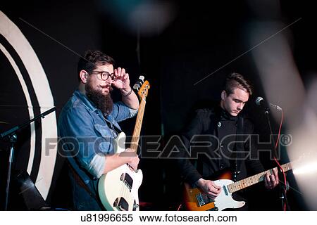 Two men playing guitars on stage View Large Photo Image Stock Photography - Two men playing guitars on stage. Fotosearch
