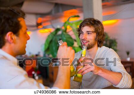 Stock Photograph - Two men with bottles of beer. Fotosearch