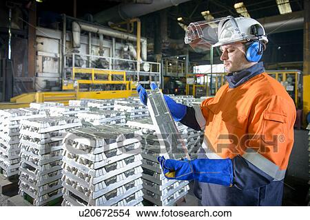 Warehouse worker checking aluminum ingot View Large Photo Image Picture - Warehouse worker checking aluminum ingot. Fotosearch