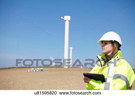 Stock Image - Wind farm and female project manager. Fotosearch