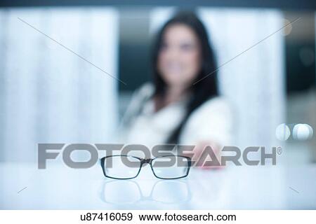 Woman and a pair of eyeglasses View Large Photo Image Stock Photo - Woman and a pair of eyeglasses. Fotosearch