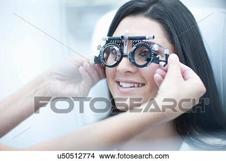 Woman having her eyes examined View Large Photo Image Picture - Woman having her eyes examined. Fotosearch