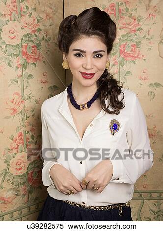 Stock Photography - Woman in vintage clothes standing in corner. Fotosearch