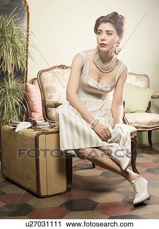 Woman in vintage clothes waiting in lobby with suitcase View Large Photo Image Stock Image - Woman in vintage clothes waiting in lobby with suitcase. Fotosearch