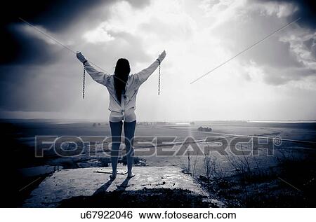 Woman wearing chains and straitjacket looking out over land View Large Photo Image Stock Photograph - Woman wearing chains and straitjacket looking out over land. Fotosearch