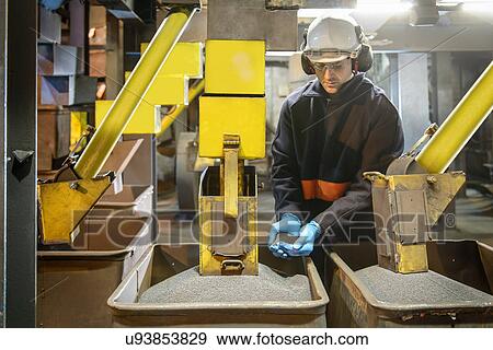 Worker checking steel shot in steel foundry View Large Photo Image Stock Photo - Worker checking steel shot in steel foundry. Fotosearch