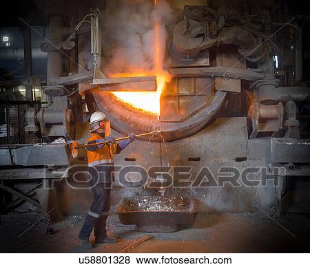 Worker removing liquid aluminum from furnace at recycling plant View Large Photo Image Stock Photo - Worker removing liquid aluminum from furnace at recycling plant. Fotosearch