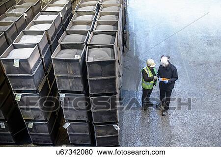 Workers monitoring crates of steel shot in steel foundry View Large Photo Image Stock Image - Workers monitoring crates of steel shot in steel foundry. Fotosearch