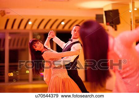 Stock Photo - Young ballroom dancers practising in mirror. Fotosearch