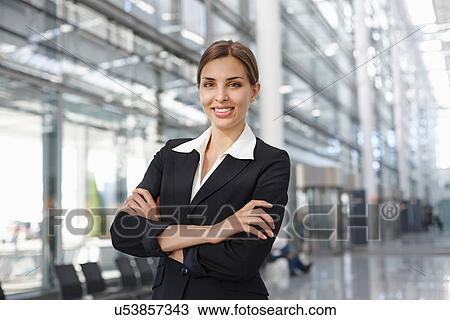 Young businesswoman standing in lobby, portrait View Large Photo Image Stock Image - Young businesswoman standing in lobby, portrait. Fotosearch