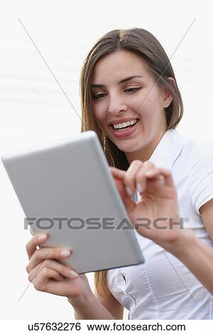 Young businesswoman using digital tablet, smiling View Large Photo Image Stock Photograph - Young businesswoman using digital tablet, smiling. Fotosearch