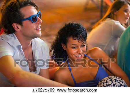 Young couple at indoor beach party View Large Photo Image Stock Photo - Young couple at indoor beach party. Fotosearch