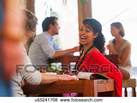 Young couple chatting in cafe View Large Photo Image Stock Photo - Young couple chatting in cafe. Fotosearch