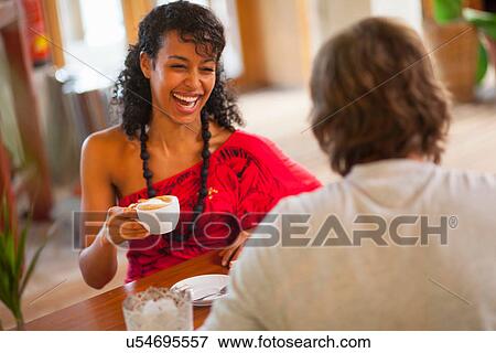 Young couple having coffee in cafe View Large Photo Image Stock Photo - Young couple having coffee in cafe. Fotosearch
