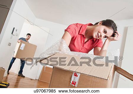Stock Photography - Young couple moving into new home. Fotosearch
