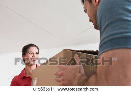 Stock Image - Young couple with cardboard box. Fotosearch
