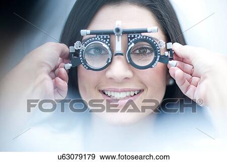 Stock Photo - Young female having her eyes examined. Fotosearch