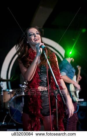 Young female singing on stage in club View Large Photo Image Picture - Young female singing on stage in club. Fotosearch