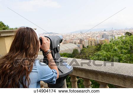 Picture - Young female tourist looking at view of Barcelona, Spain. Fotosearch
