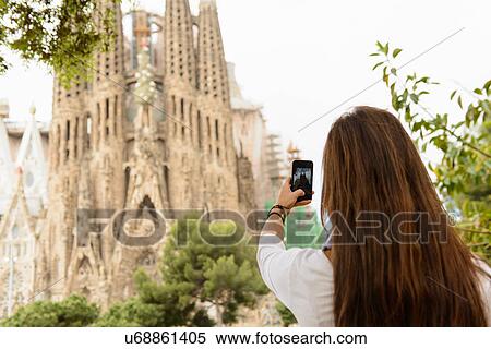 Young female tourist photographing Sagrada Familia, Barcelona, Spain View Large Photo Image Stock Photography - Young female tourist photographing Sagrada Familia, Barcelona, Spain. Fotosearch