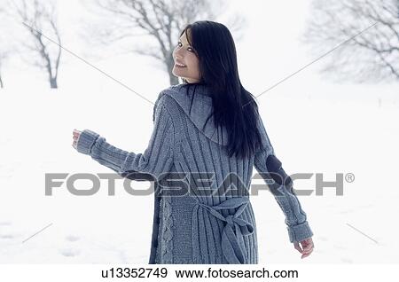 Young female walking in snowy field View Large Photo Image Stock Photo - Young female walking in snowy field. Fotosearch