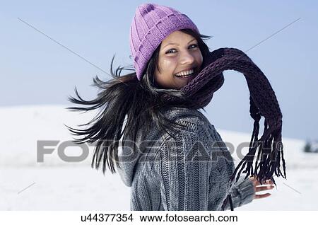 Picture - Young female wrapped up and having fun. Fotosearch