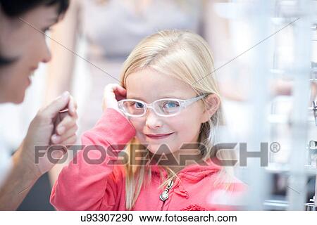 Young girl on choosing eyeglasses View Large Photo Image Stock Image - Young girl on choosing eyeglasses. Fotosearch