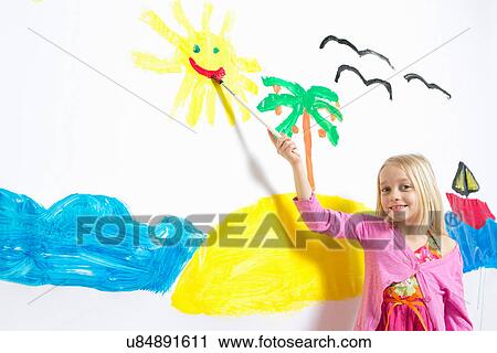Young girl painting smiling sunshine face on wall View Large Photo Image Stock Image - Young girl painting smiling sunshine face on wall. Fotosearch