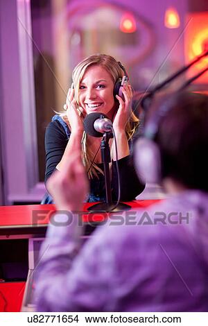 Young man and woman broadcasting in recording studio View Large Photo Image Picture - Young man and woman broadcasting in recording studio. Fotosearch