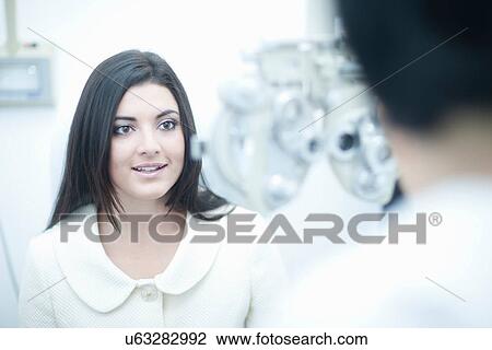 Young woman at opticians View Large Photo Image Stock Image - Young woman at opticians. Fotosearch