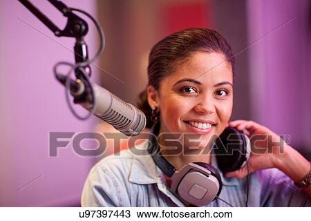 Young woman broadcasting in recording studio, portrait View Large Photo Image Stock Image - Young woman broadcasting in recording studio, portrait. Fotosearch