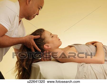 Young woman having head massage View Large Photo Image Stock Image - Young woman having head massage. Fotosearch