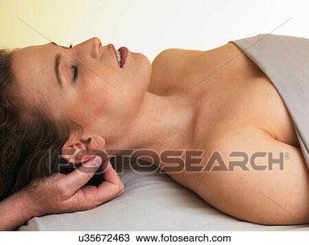 Young woman having her head massaged View Large Photo Image Stock Image - Young woman having her head massaged. Fotosearch