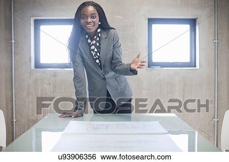 Young woman in boardroom View Large Photo Image Stock Photograph - Young woman in boardroom. Fotosearch