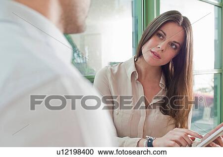 Young woman in office pointing at digital tablet screen View Large Photo Image Stock Image - Young woman in office pointing at digital tablet screen. Fotosearch