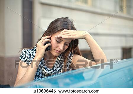 Young woman outside office building using mobile phone View Large Photo Image Stock Photography - Young woman outside office building using mobile phone. Fotosearch