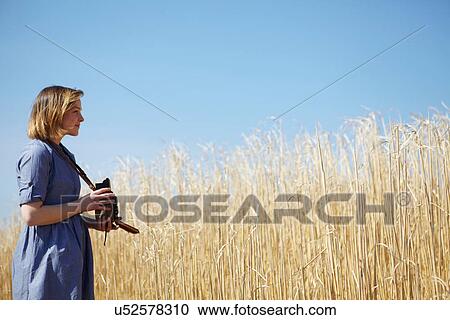 Young woman photographing reeds View Large Photo Image Stock Image - Young woman photographing reeds. Fotosearch