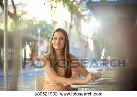 Young woman waiting in street cafe View Large Photo Image Stock Image - Young woman waiting in street cafe. Fotosearch
