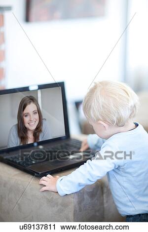 Baby boy distracted on video call to mother View Large Photo Image Stock Image - Baby boy distracted on video call to mother. Fotosearch