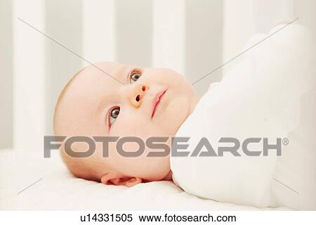 Baby in crib by herself View Large Photo Image Stock Photography - Baby in crib by herself. Fotosearch