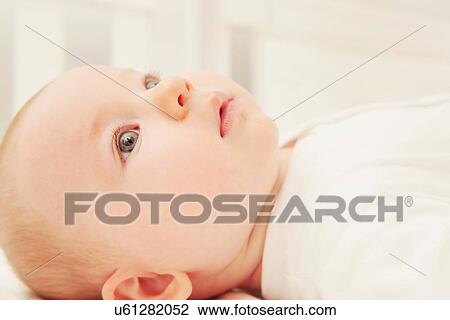 Baby in the crib daydreaming View Large Photo Image Stock Image - Baby in the crib daydreaming. Fotosearch