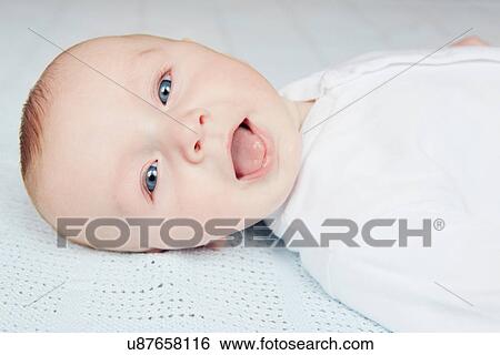 Stock Photograph - Baby sticking out tongue. Fotosearch
