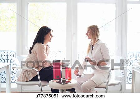 Stock Image - Beautician demonstrating beauty products. Fotosearch