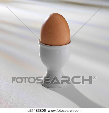 Boiled egg in egg cup View Large Photo Image Stock Photograph - Boiled egg in egg cup. Fotosearch