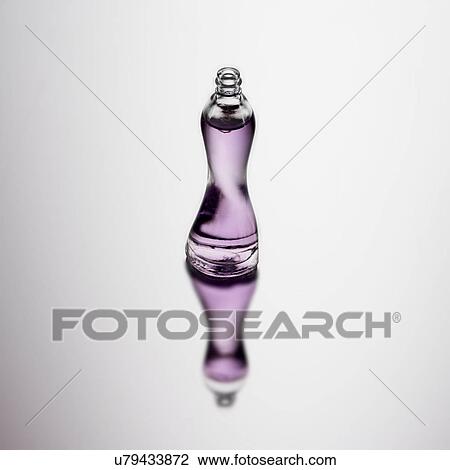 Stock Image - Bottle of perfume with reflection. Fotosearch