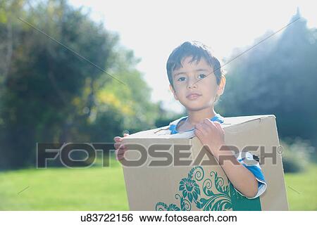 Boy wearing cardboard box View Large Photo Image Stock Photograph - Boy wearing cardboard box. Fotosearch