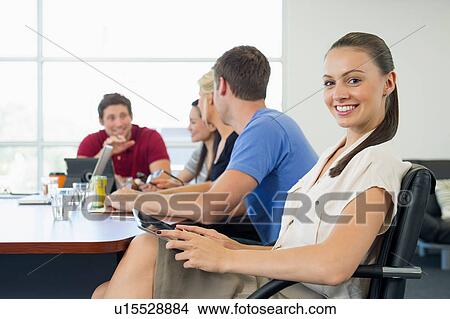 Picture - Business executive turning away from brainstorming meeting. Fotosearch