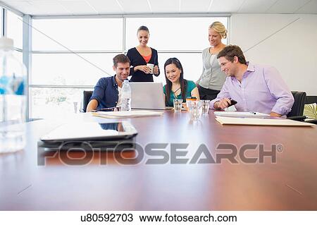 Stock Image - Business executives at brainstorming meeting. Fotosearch