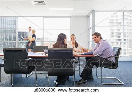 Stock Image - Business executives at brainstorming meeting. Fotosearch
